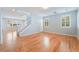 Open-concept living area with hardwood floors, a staircase, and plantation shutters at 11673 Pride Hill St, Las Vegas, NV 89183