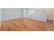 Spacious living area with hardwood flooring, light gray walls and staircase access at 11673 Pride Hill St, Las Vegas, NV 89183