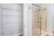 Shower stall featuring glass doors next to shelves for linen storage in bathroom at 11673 Pride Hill St, Las Vegas, NV 89183