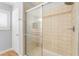 Close up of the tiled shower, enclosed in glass, with a shower head at 11673 Pride Hill St, Las Vegas, NV 89183