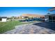 Expansive backyard features a thatched tiki bar, sparkling pool, and lush lawn creating an entertainer's dream at 120 Chartan Ave, Las Vegas, NV 89183