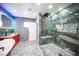 Modern bathroom featuring glass shower, pebble floor, dual vanity, and accent lighting for a spa-like experience at 120 Chartan Ave, Las Vegas, NV 89183