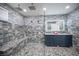 Lavish bathroom with double shower heads, a bench, double vanity, and decorative tile at 120 Chartan Ave, Las Vegas, NV 89183