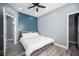 Cozy bedroom with a queen bed, gray walls, a blue accent wall, and wood-look floors at 120 Chartan Ave, Las Vegas, NV 89183