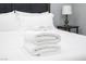 Close-up of folded towels on a neatly made bed at 120 Chartan Ave, Las Vegas, NV 89183