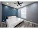 Relaxing bedroom with a blue accent wall, wood-look floors, and a ceiling fan at 120 Chartan Ave, Las Vegas, NV 89183