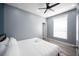 Bright bedroom featuring a ceiling fan, gray walls, wood-look floors, and a large window at 120 Chartan Ave, Las Vegas, NV 89183