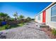 Well-maintained exterior with paved walkway, lush landscaping, and a welcoming entrance at 120 Chartan Ave, Las Vegas, NV 89183