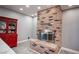 Inviting brick fireplace is the centerpiece of the space, flanked by a built-in display case, adding warmth and character at 120 Chartan Ave, Las Vegas, NV 89183