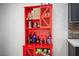 Custom red cabinet with wine glass holders and storage for liquor and snacks at 120 Chartan Ave, Las Vegas, NV 89183