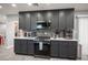Modern kitchen with gray cabinets, stainless steel appliances, and brick backsplash at 120 Chartan Ave, Las Vegas, NV 89183