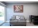 Cozy living room with grey sofa, decorative pillows, and a modern art piece on the wall at 120 Chartan Ave, Las Vegas, NV 89183