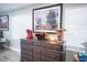 Tastefully decorated living room features vintage cabinet and colorful artwork, creating a comfortable and inviting atmosphere at 120 Chartan Ave, Las Vegas, NV 89183