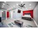 Bright main bedroom with king bed, red accent wall, and television at 120 Chartan Ave, Las Vegas, NV 89183