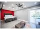 Spacious main bedroom featuring a king bed, ceiling fan, and sliding glass door to the backyard at 120 Chartan Ave, Las Vegas, NV 89183