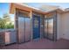 Complete outdoor kitchen area with stainless steel appliances, a blue door, and dual fridges for convenient outdoor entertaining at 120 Chartan Ave, Las Vegas, NV 89183