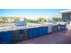 A modern outdoor kitchen with stainless steel appliances, stone countertops, and blue cabinetry for stylish backyard cooking at 120 Chartan Ave, Las Vegas, NV 89183