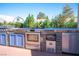 Outdoor kitchen with stainless steel appliances, stone accents, and blue cabinets, perfect for backyard entertaining and cooking at 120 Chartan Ave, Las Vegas, NV 89183