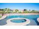 Inviting in-ground pool and spa with waterfall feature and manicured landscaping at 120 Chartan Ave, Las Vegas, NV 89183