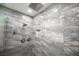 Elegant shower with marble tile and rainfall shower head at 120 Chartan Ave, Las Vegas, NV 89183