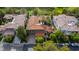 An aerial perspective of a spacious home with a terracotta roof, surrounded by trees and a pristine lawn at 12097 Oakland Hills Dr, Las Vegas, NV 89141