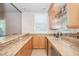 Stylish bar area featuring custom cabinetry, granite countertops, and built-in wine storage at 12097 Oakland Hills Dr, Las Vegas, NV 89141
