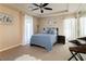 Cozy bedroom with plush carpet, ceiling fan, comfortable bed and an abundance of natural light at 12097 Oakland Hills Dr, Las Vegas, NV 89141