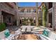Charming courtyard with elegant furniture and lush greenery, creating a serene outdoor living space at 12097 Oakland Hills Dr, Las Vegas, NV 89141