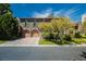 Charming two-story home featuring a brick driveway, two-car garage and beautiful landscaping at 12097 Oakland Hills Dr, Las Vegas, NV 89141