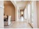 Bright hallway with stone floors, arched doorway and beautiful French doors and plenty of natural light at 12097 Oakland Hills Dr, Las Vegas, NV 89141