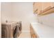 Bright laundry room with modern washer and dryer and ample counter space at 12097 Oakland Hills Dr, Las Vegas, NV 89141