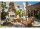 A cozy backyard area features a stone fireplace and comfortable seating, ideal for outdoor entertaining at 12097 Oakland Hills Dr, Las Vegas, NV 89141
