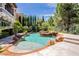 Beautiful backyard swimming pool with rock features, landscaping and a relaxing atmosphere at 12097 Oakland Hills Dr, Las Vegas, NV 89141