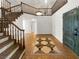 Elegant foyer boasts tile flooring, statement staircase, and modern lighting fixtures at 132 Montclair Dr, Henderson, NV 89074