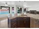 Gourmet kitchen island featuring granite countertop, stainless steel appliances, and backyard pool views at 132 Montclair Dr, Henderson, NV 89074