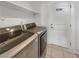 Convenient laundry room equipped with modern washer and dryer units and ample shelving for storage at 132 Montclair Dr, Henderson, NV 89074