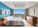 Comfortable bedroom featuring a large window with city views, a gray accent wall and natural lighting at 150 Las Vegas Blvd # 918, Las Vegas, NV 89101