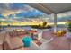 Relaxing rooftop terrace with comfortable seating, lush plants, and panoramic city views at sunset at 150 Las Vegas Blvd # 918, Las Vegas, NV 89101