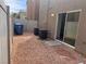 This backyard has gravel, trash receptacles, AC units, and a sliding glass door at 1820 Peridot Point St, Las Vegas, NV 89106