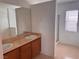 Bathroom with double sink vanity, framed mirror, walk-in shower, and a window for natural light at 1820 Peridot Point St, Las Vegas, NV 89106