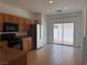 Functional kitchen with stainless steel refrigerator, tile floor, and access to the backyard at 1820 Peridot Point St, Las Vegas, NV 89106