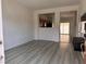 Bright living room with light vinyl floors, open to the kitchen and access to the backyard at 1820 Peridot Point St, Las Vegas, NV 89106