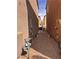 Narrow side yard with gravel landscaping between two stucco homes at 1820 Peridot Point St, Las Vegas, NV 89106