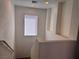 Well-lit stairway with clean white walls, leading to the upper level of the home at 1820 Peridot Point St, Las Vegas, NV 89106