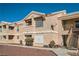 Charming multi-Gathering building featuring a neutral-toned exterior and well-maintained landscaping under a clear blue sky at 1830 N Pecos Rd # 137, Las Vegas, NV 89115