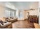 Inviting living room with hardwood floors, large windows, and comfortable seating adjacent to the dining area at 1830 N Pecos Rd # 137, Las Vegas, NV 89115
