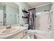 Cozy bathroom featuring a single sink vanity, toilet, and shower-tub combo with decorative shower curtain at 209 Crosswind Way, Las Vegas, NV 89145