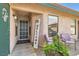 Inviting front porch with charming decor and cozy seating, great curb appeal and a welcoming entrance at 209 Crosswind Way, Las Vegas, NV 89145