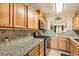Traditional kitchen showcasing oak cabinets, granite countertops, and stainless steel appliances at 209 Crosswind Way, Las Vegas, NV 89145