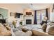 Warm living room featuring plush sofas, a decorative fireplace, and French doors leading to an outdoor space at 209 Crosswind Way, Las Vegas, NV 89145